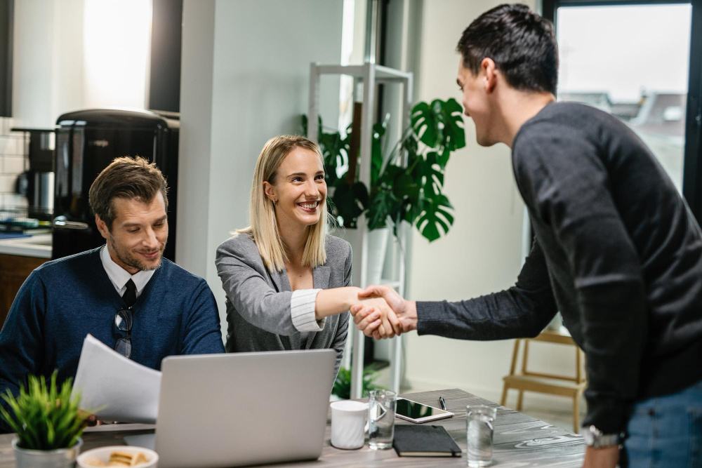 Woman and man shaking hands in the office