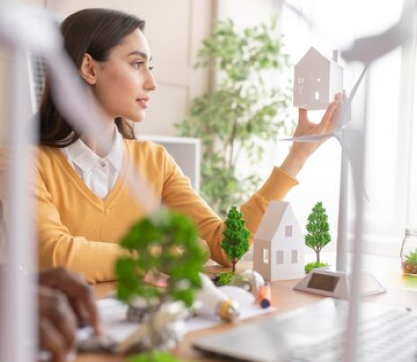 woman with a paper house in her hand